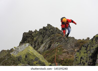 Climber On Vertical Pitch Of The Rock Climbing Route, Romania