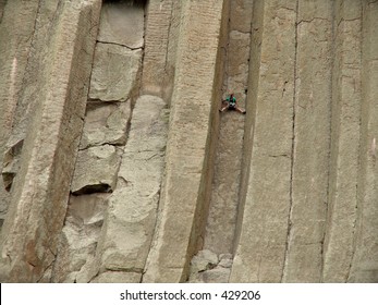 A Climber Scaling Devils Tower In Wyoming