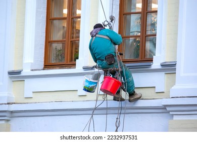 climber serves the window and the facade of a residential building under repair. construction business industry - Shutterstock ID 2232937531