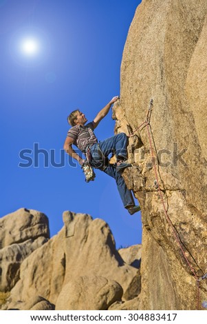 Similar – Image, Stock Photo Rock climber clinging to a cliff.