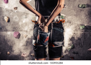 Climber woman coating her hands in powder chalk magnesium and preparing to climb , close up - Powered by Shutterstock