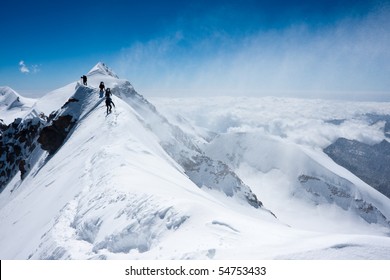 Climbers Balancing In Blizzard On A Narrow Ridge Of Lyskamm (aka Maneater, 4480 M)