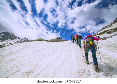 Climbers Climbing Mountain With Snow Field