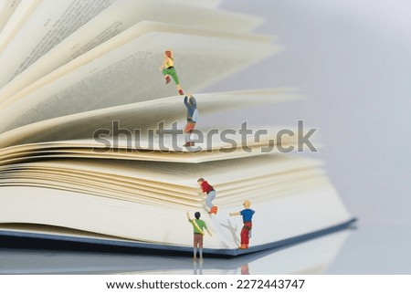 climbers, mountaineers climb a book in teamwork