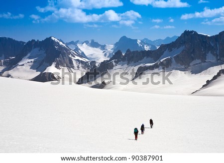 climbers walk up on glacier in the mountain