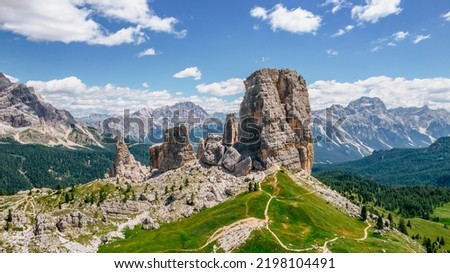 Climbing in Cinque Torri,Dolomites,Italy.Five towers and rock formations close to Cortina d'Ampezzo attract many tourists.Picturesque Dolomite Alps,active summer holiday,steep cliffs.Adventure concept