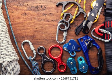 Climbing Equipment Outdoor For A Mountain Trip Or Rescue
With Rope Carabiners Ascender Belay/rappel Device, Over Concrete Background With Copy Space On Wooden Background, Top View. Travel Concept