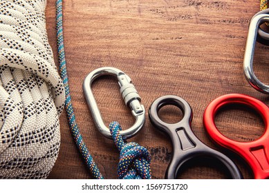 Climbing Equipment Outdoor For A Mountain Trip Or Rescue
With Rope Carabiners Ascender Belay/rappel Device, Over Concrete Background With Copy Space On Wooden Background, Top View. Travel Concept