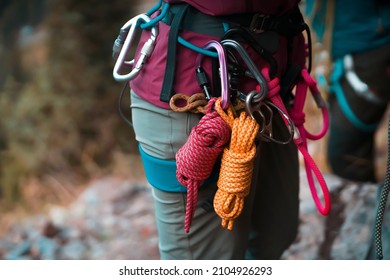 Climbing Equipment, Ropes, Carabiners, Harness, Belay, Close-up Of A Rock-climber Put On By A Girl, The Traveler Leads An Active Lifestyle And Is Engaged In Mountaineering.