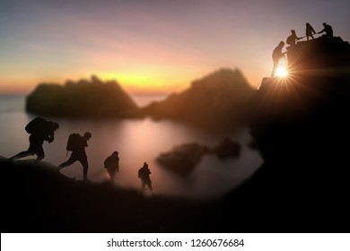 Climbing Group Helping Hike Up On Top Of A Mountain And Climbing Group Friends Wolking To Hike Up Moutain .Teamwork , Helps ,Success, Winner And Leadership Concept .