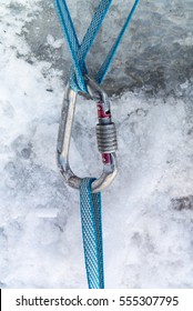 Climbing Harnesses Blue Cords Are Connected Together Using Carabiner, Against The Background Of Snow And Ice