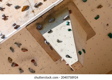 Climbing Holds On Worn Wall Outside. Though Bouldering Parkour. Artificial Rock Climbing Wall At Park.