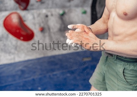 climbing magnesium on the hands of an athlete in a bouldering center