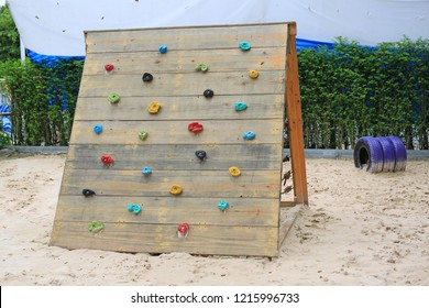 Kid’s climbing on wooden wall outdoor. - Powered by Shutterstock