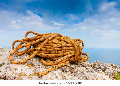 Climbing Rope Coiled Up And Placed On The Rock