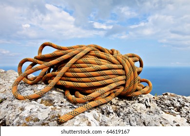 Climbing Rope Coiled Up And Placed On The Rock