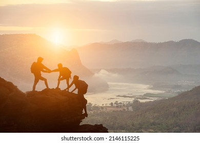 Climbing Team Are On The Climb To The Cliff,hiking And Team Work Concept.    Mountaineer Climbing A Steep Cliff.