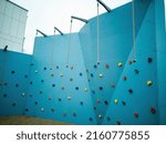 Climbing wall, blue climbing wall. Geometry both in the city and buildings.