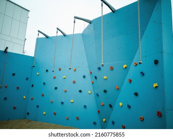 Climbing wall, blue climbing wall. Geometry both in the city and buildings.