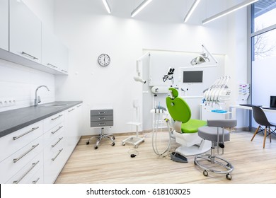 Clinic interior with modern dental unit, white furniture and grey worktop - Powered by Shutterstock