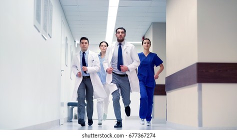 clinic, people, health care and medicine concept - group of medics running along hospital - Powered by Shutterstock