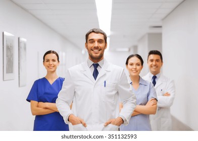 clinic, profession, people, health care and medicine concept - happy group of medics or doctors at hospital corridor - Powered by Shutterstock