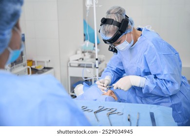 Clinic surgeon works with an assistant in an operating room - Powered by Shutterstock