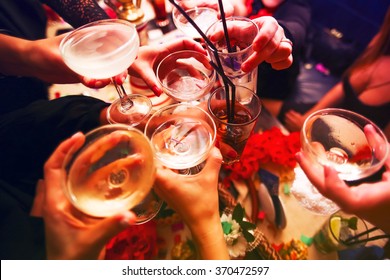 Clinking glasses with alcohol and toasting, party - Shutterstock ID 370472597