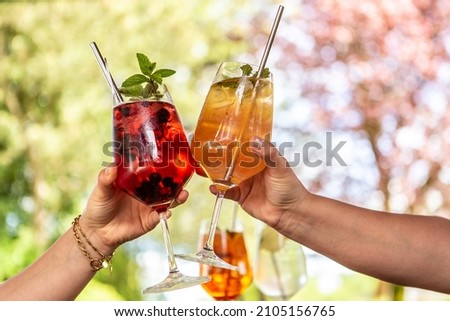 Clinking glasses with delicious summer cocktails