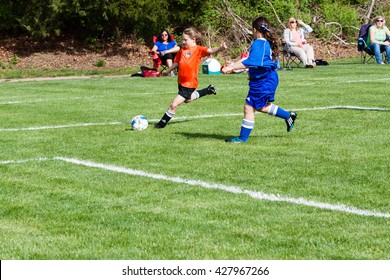 Clinton, CT, USA - May 21, 2016: Daytime Scene Of Young Girls Playing Soccer In An All Girls Team On May 21, 2016. The Game Is An Organized Youth Soccer Game.
