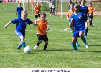 Clinton, CT, USA - May 21st., 2016: Daytime Scene Of Young Girls Playing Soccer In An All Girls Team On May 21st, 2016. The Game Is An Organized Youth Soccer Game.
