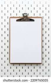 Clipboard With Blank Paper And Copyspace For Text On Peg Board