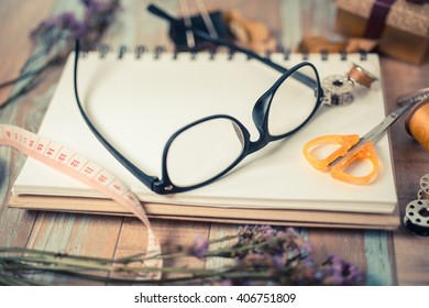 Clipboard with Blank Paper and eyeglasses on Wooden Table. Top View of Desk with Copy space for text or image