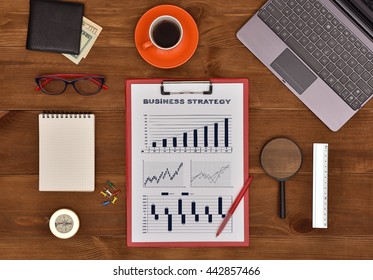 Clipboard With Drawing Buisness Strategy On Wooden Table.