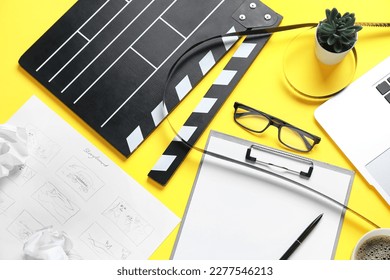 Clipboard with movie clapper, film reel and eyeglasses on yellow background - Powered by Shutterstock