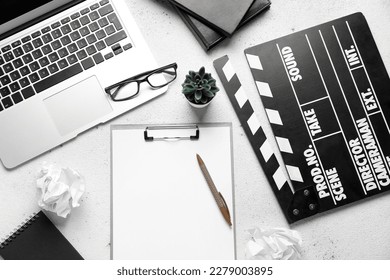 Clipboard with movie clapper, plant, eyeglasses and laptop on white background - Powered by Shutterstock