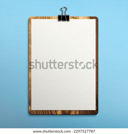 Clipboard on blue fabric surface