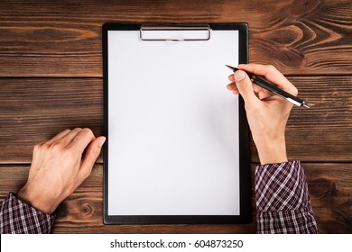 Clipboard On A Wooden Table