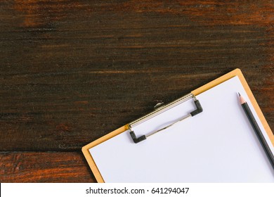 Clipboard And Pen On Old Wood Table At Office