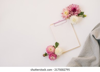 Clipboard tablet pad with blank paper sheet. Artist home office desk workspace. Flat lay, top view mockup copy space