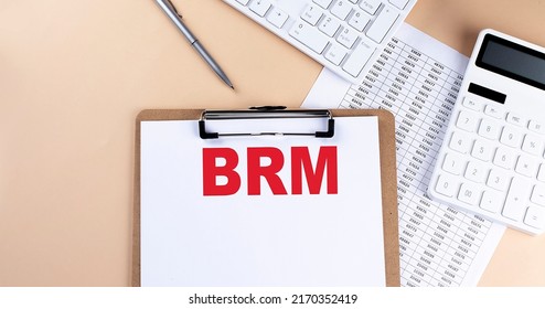 clipboard with white blank paper text BRM Business Reference Model , keyboard calculator and chart,business concept.