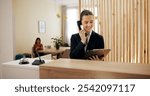 Clipboard, woman and receptionist in hotel with telephone, schedule booking and checklist on counter. Help desk, hospitality and concierge with calling for customer service, assistance or reservation