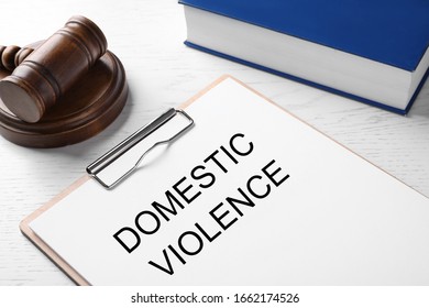 Clipboard with words DOMESTIC VIOLENCE and gavel on white wooden table, closeup - Shutterstock ID 1662174526