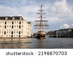 Clipper Stad Amsterdam docked at the National Maritime Museum in Amsterdam. This impressive sail ship makes for a perfect photo opportunity to passing by tourists. 