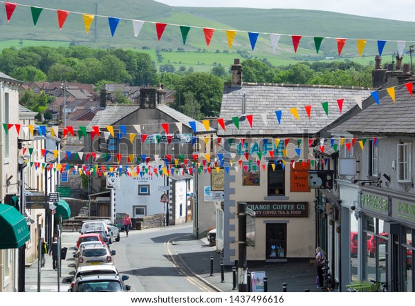 Clitheroe, Lancashire/UK - June\
16th 2019: view down shopping street in Clitheroe, a small town in\
the Ribble Valley, with woodland and hills in the\
background