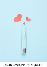 clitoral vibrator with hearts on a blue background. Minimal sex concept