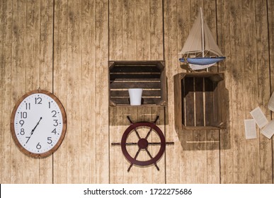 A Clock, Boat Wheel, Sailboat And Logbook Pages On Wooden Wall, Ship's Cabin Interior Concept