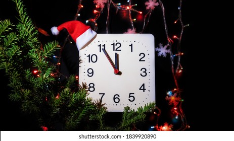 Clock In Branches Of New Year's Fir On Black Background. Second Hand Moves In Circle Of Mechanical Clock And Show Twelve O'clock At  Midnight And Eve Of Christmas. Holiday Concept, Time Lapse, Closeup