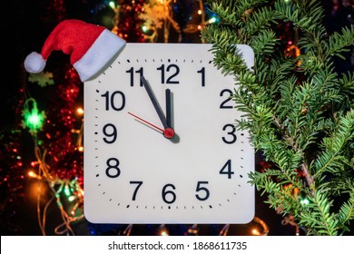 Clock In Branches Of New Year's Fir On Black Background. Second Hand Moves In Circle Of Mechanical Clock And Show Twelve O'clock At  Midnight And Eve Of Christmas. Holiday Concept, Time Lapse, Closeup