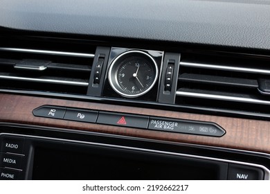 Clock In The Center Interior Car. Modern Luxury Car With Natural Wood Panel. Detailing. Interior Of Prestige Car. Warning Light Switch In A Car.